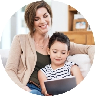 Mother and child sitting together looking at a tablet 