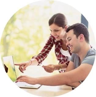 Husband and wife viewing laptop screen together